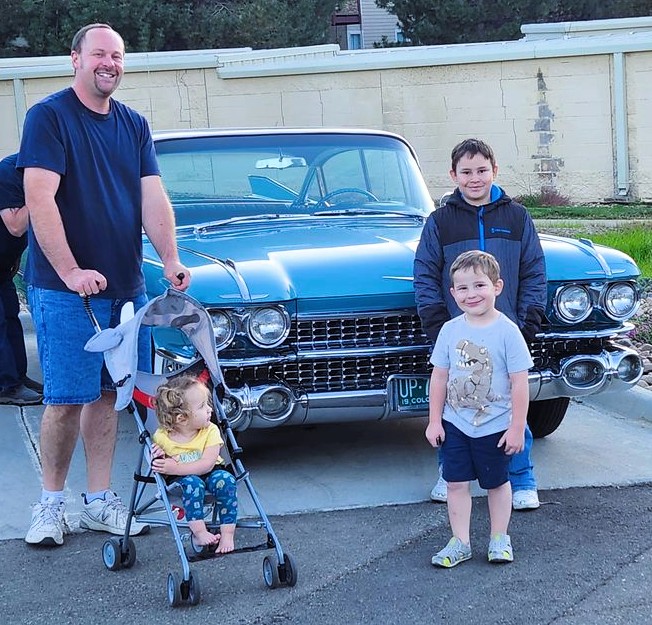 Eric and his kids in front of a '59 Cadillac